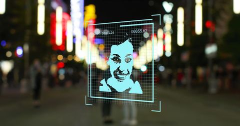 Digital Portrait Overlay on City Street at Night Indicating Tech Advancements