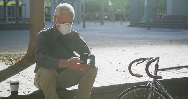 Senior Man with Face Mask Using Smartphone in Urban Setting - Download Free Stock Images Pikwizard.com