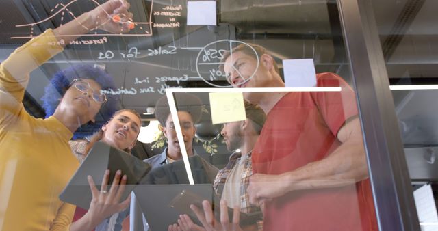 Diverse Team Brainstorming Ideas on Transparent Board in Modern Office - Download Free Stock Images Pikwizard.com