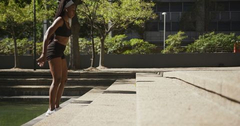 Athletic woman jumping stairs outdoors for fitness training