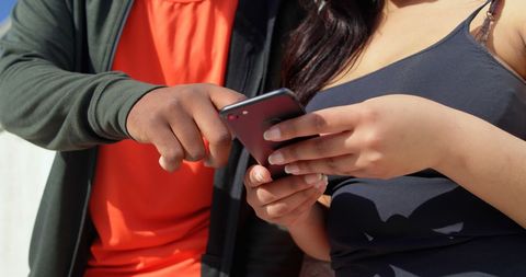 Couple Exploring Mobile Phone on Sunny Day - Download Free Stock Images Pikwizard.com