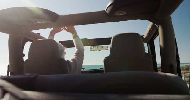 Senior Man Adjusting Convertible Car Roof Near Coastline - Download Free Stock Images Pikwizard.com