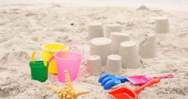 Colorful Sand Buckets and Beach Toys on Sandy Beach - Download Free Stock Images Pikwizard.com