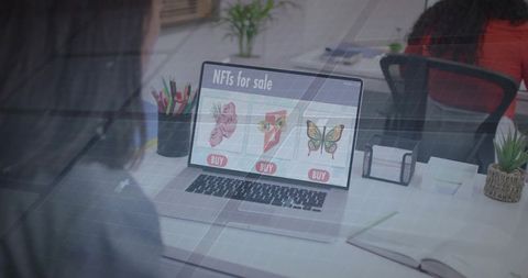 Nft listings displayed on laptop in modern office