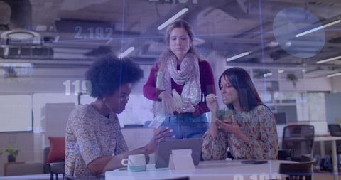 Diverse Team Collaborating in Modern Office with Financial Projections