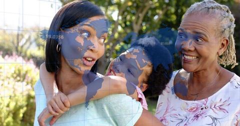 Three-generation family sharing joyful moment in sunlit garden with world map overlay