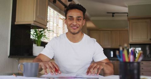 Smiling Latin Man Video Calling from Home Kitchen