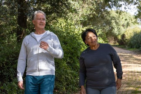 Active Senior Couple Enjoying Morning Walk on Park Trail