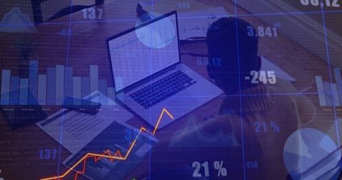 Analyzing Financial Data on Laptop at Modern Office Desk