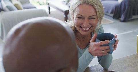 Senior Couple Enjoying Leisure Time at Home with Coffee