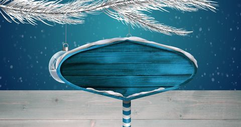 Snowy christmas road sign with ornaments and copy space