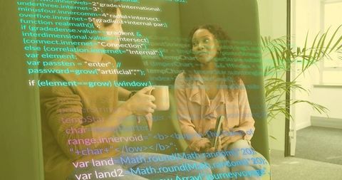 Software Developers Collaborating on Code in Modern Office Lounge