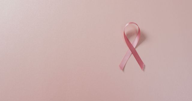 Pink Ribbon Symbolizing Breast Cancer Awareness on Pink Background - Download Free Stock Photos Pikwizard.com