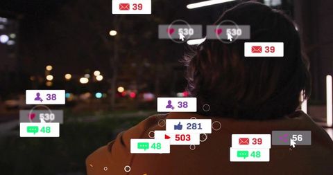 Man standing on city walkway at night with floating social media notification badges
