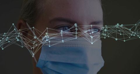 Healthcare professional wearing protective mask with digital nodes