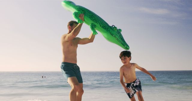 Father and Son Playing with Inflatable Crocodile on Beach - Download Free Stock Images Pikwizard.com