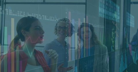 Businesswomen Analyzing Digital Data Projections in Office Meeting
