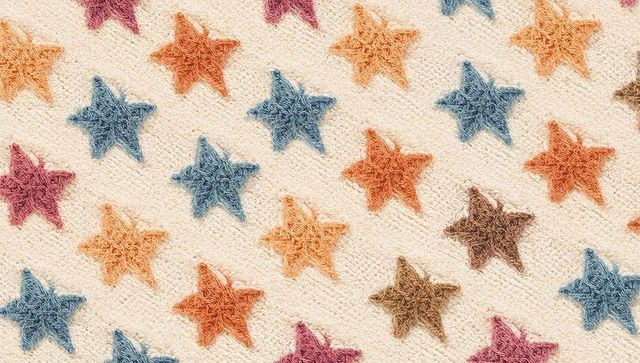 Tufted star knit fabric pattern cream background with colorful plush stars textile swatch