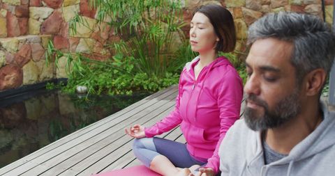 Couple Meditating in Serenity on Backyard Terrace