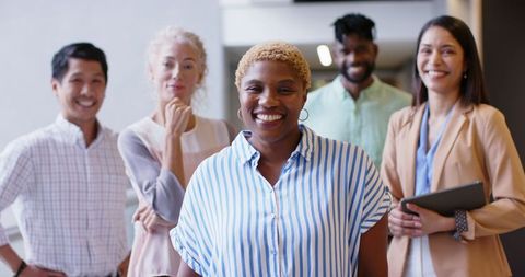 Diverse Business Team Smiling Together in Office Environment