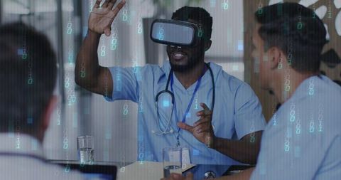 Medical team using virtual reality clinical training while clinician demonstrating controls