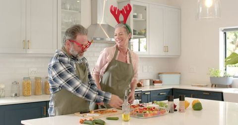 Joyful Couple Preparing Holiday Meal in Festive Kitchen