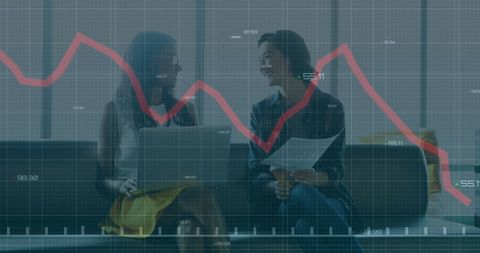 Women Analyzing Financial Data in Modern Office Space