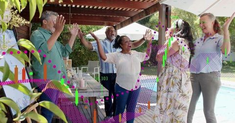 Friends celebrating on poolside patio under pergola, raising arms and laughing with joy