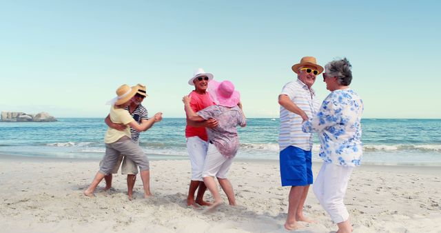 Senior couples dancing at the beach