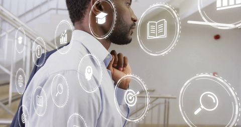 African american businessman with digital interface symbols