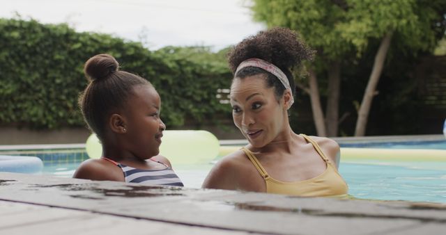 Mother and daughter enjoying swimming pool outdoors - Download Free Stock Images Pikwizard.com