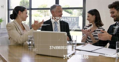 Business Team Applauding After Successful Presentation with Laptop and Digital Data Overlay