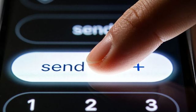 Closeup Fingertip Pressing Send Button on Smartphone Touchscreen with Glossy Reflection