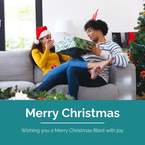couple sharing christmas joy in festive living room - Download Free Stock Templates Pikwizard.com