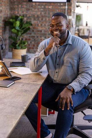 Smiling Professional at Desk Enhancing Workplace Atmosphere