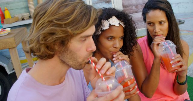 A diverse group of young adults enjoys cold beverages together, with copy space - Download Free Stock Photos Pikwizard.com