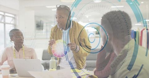 Creative director leading design meeting with color wheel