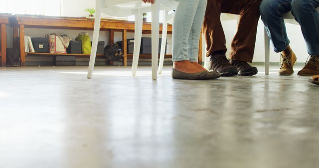 Close-Up of Legs and Feet in Casual Meeting Room - Download Free Stock Images Pikwizard.com