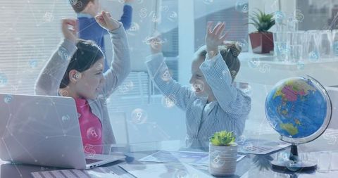 Enthusiastic children celebrating learning in digital classroom