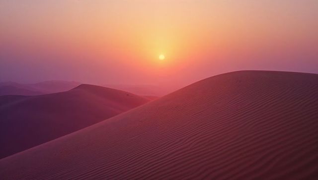 Serene desert sunset with rippled sand dunes