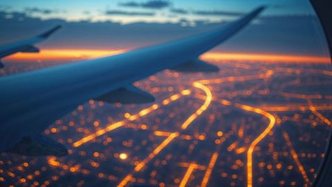 Aerial Sunset View of Cityscape from Airplane Wing
