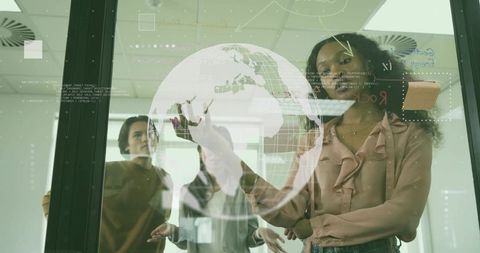 Innovative business team collaborating with digital globe overlay