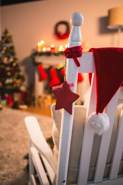Close-up of santa hat and christmas decoration hanging on chair