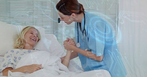 Nurse holding patient's hand at bedside offering comfort with digital health overlay