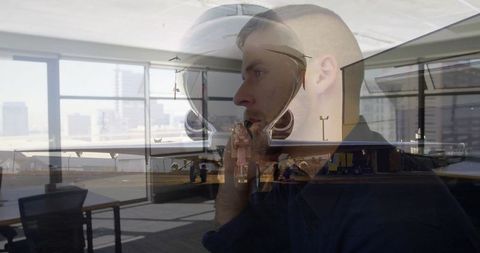 Business traveler communicating in airport lounge with airplane reflection