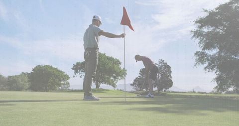 Golfers Enjoying Leisurely Game Puttting on Sunny Course