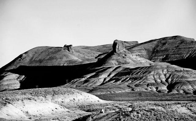 Monochrome depiction of rugged desert mountains showcasing contrasting shadows and dramatic terrain. Ideal for nature photography collections, travel blogs, and artistic décor highlighting the stark beauty of remote landscapes.