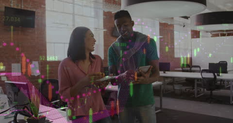 Diverse Colleagues Collaborating with Financial Data in Office