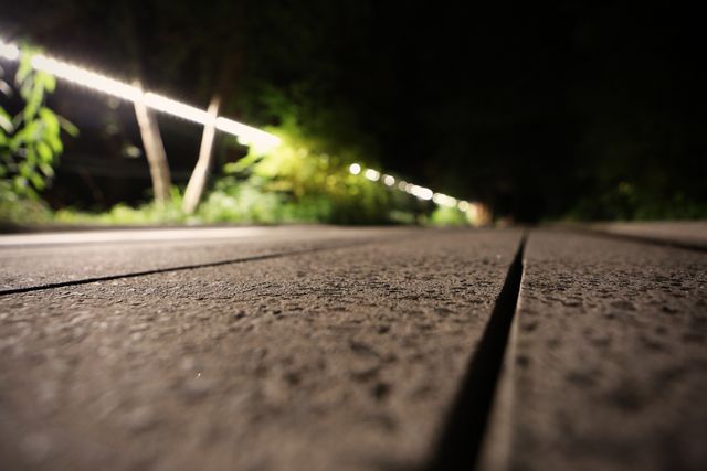 Close-up of Wooden Boardwalk at Night with String Lights - Download Free Stock Images Pikwizard.com