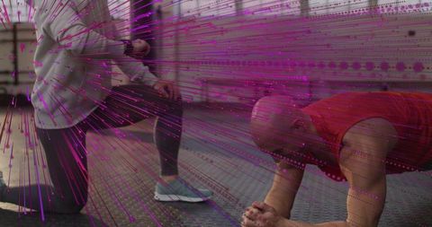 Kneeling trainer assisting man holding plank with magenta overlay for core training